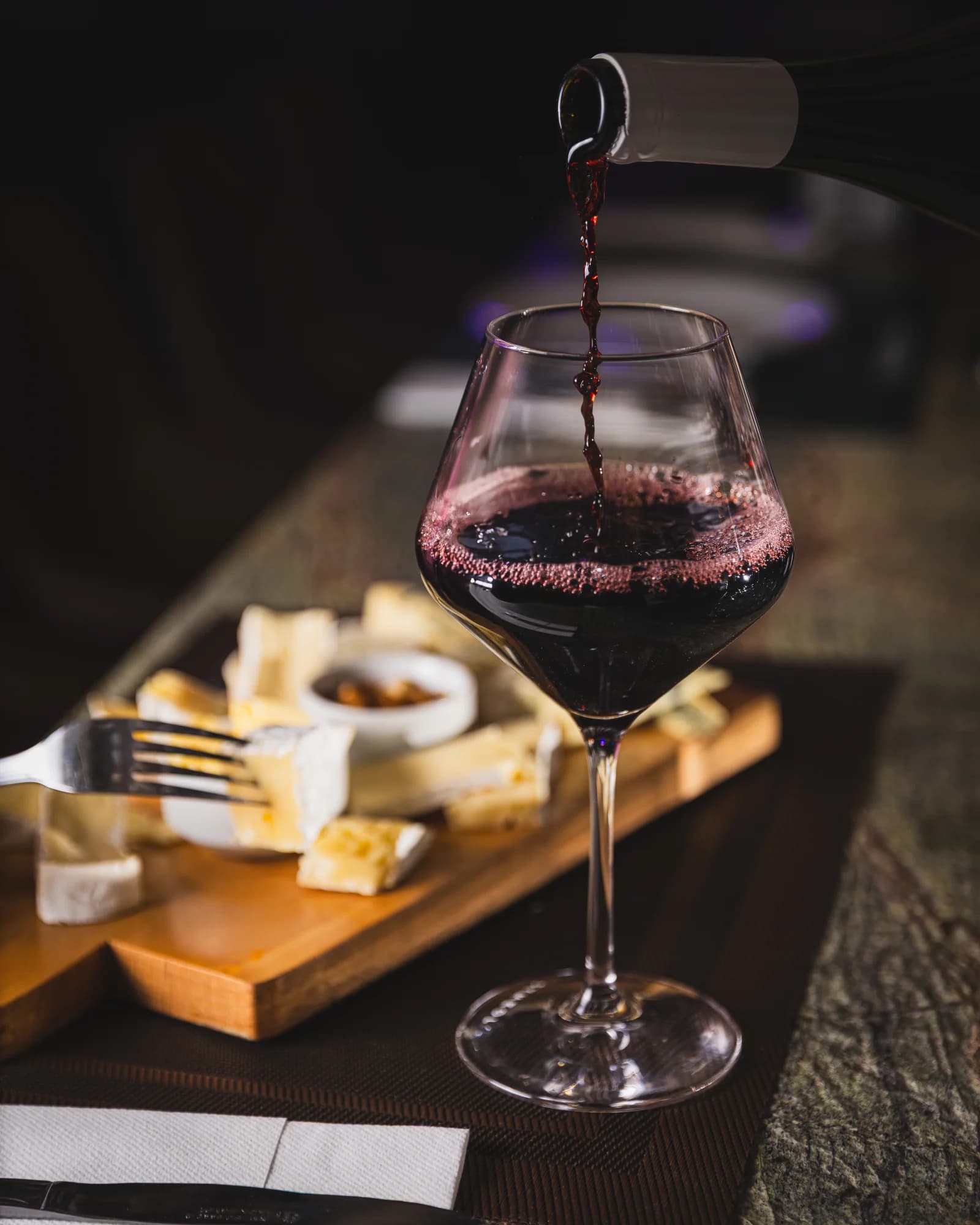 A cocktail being poured at the bar